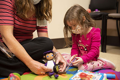 A child participates in play therapy